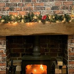 a brick fireplace with christmas lights on it