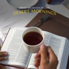 someone is reading a book and holding a cup of tea in their hand with the words desert mornings above them