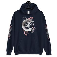 Japanese Blossom Hoodie, Cherry Blossom Moon Crescent Hoodie, Aesthetic Hoodie, Aesthetic Clothing, Kawaii, Flowers Anime Unisex Hoodie Everyone needs a cozy go-to hoodie to curl up in, so go for one that's soft, smooth, and stylish. It's the perfect choice for cooler evenings! * 50% pre-shrunk cotton, 50% polyester * Fabric weight: 8.0 oz/yd² (271.25 g/m²) * Air-jet spun yarn with a soft feel and reduced pilling * Double-lined hood with matching drawcord * Quarter-turned body to avoid crease do Harajuku Style Graphic Print Hoodie For Spring, Harajuku Style Hoodie With Graphic Print For Spring, Cotton Aesthetic Hooded Sweatshirt, Aesthetic Cotton Hooded Hoodie, Cotton Hooded Sweatshirt With Aesthetic Style, Aesthetic Long Sleeve Cotton Hoodie, Aesthetic Winter Hoodie Sweatshirt, Aesthetic Cotton Hoodie, Aesthetic Cotton Hoodie Sweatshirt