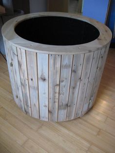 a round wooden table sitting on top of a hard wood floor