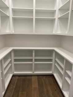 empty white shelves in a room with wood floors