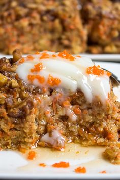 a piece of carrot cake on a plate with a fork