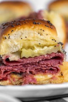 a close up of a sandwich on a plate with the words hot pastrami sliders