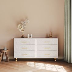 a white dresser sitting next to a window in a room with wooden floors and walls