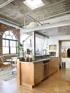 an open kitchen and living room with exposed ceilings