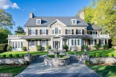 a large house with a fountain in the front yard