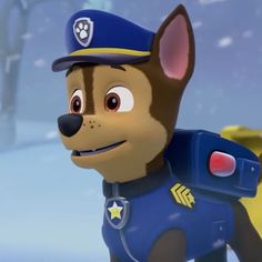 a cartoon dog wearing a police uniform standing in the snow with his paw patrol hat on