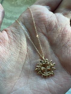 Our Gold Sun Necklace Talisman was created to be a protective force for you to wear and carry with you. This Gold Sun Pendant radiates life and energy with its intricately carved gold sun face pendant. This timeless sun charm shimmers with divine radiance and will be a source of positivity and a reminder to embrace the light within. Artisan-crafted from recycled solid 14k gold, made to order Hung from a 14k yellow gold 1mm chain measuring 18" long. Weighs approx. 3.5 grams We will be donating a Spiritual Sun And Moon Medallion Necklace, Spiritual Pendant Necklace With Sun And Moon Design, Symbolic Sun Design Jewelry For Gifts, Bohemian Yellow Gold Jewelry With Sun Design, Spiritual Sun And Moon Pendant Necklace, Symbolic Jewelry With Sun Design Round Pendant, Symbolic Round Pendant Jewelry With Sun Design, Gold Spiritual Necklace With Sun Design, Gold Necklace With Sun And Moon Design