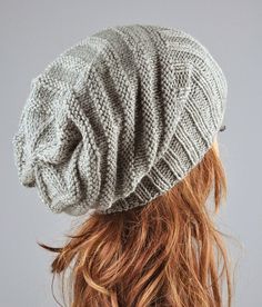 a woman wearing a gray knitted hat