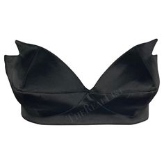 Presenting a stunning black satin Thierry Mugler pointed bralette, designed by Manfred Mugler. From the 1980s, this bralette is constructed entirely of shiny black satin. The bralette features a sweetheart cut and is made complete with pointed accents on either cut, giving this bralette an undeniable Mugler touch. A must-have for any Thierry Mugler lover, this bralette can be sported on its own or layered with your favorite blazer. Approximate measurements: Size - 42FR Top of bust to hem: 5" Bus Black Crop Top With Built-in Bra For Evening, Party Satin Crop Top With Built-in Bra, Elegant Low-cut Crop Top For Party, Fitted Satin Bra With Removable Pads, Elegant Evening Crop Top With Built-in Bra, Elegant Satin Bra, Summer Party Satin Bra, Chic Evening Bra With Triangle Top, Elegant Satin Bra For Party