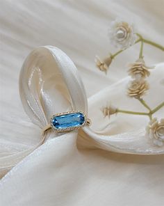 This Fashion Gemstone Ring Will Be A Show Stopper! From The Designers At Pejay Creations. The Featuring Stone Is A Oval Cut Blue Topaz. Mounting Features 0.11Ctw Round Cut Diamonds, With G/H In Color And SI1-2 In Clarity. Stop By And See This Beautiful Ring Today! Luxury Topaz Open Ring With Center Stone, Luxury Elegant Topaz Ring With Center Stone, Luxury Unique Topaz Ring As Gift, Luxury Crystal Topaz Ring, Luxury Topaz Crystal Ring, Luxury Blue Topaz Jewelry With Gemstone Accents, Luxury Exquisite Blue Topaz Jewelry, Luxury Antique Topaz Jewelry, Elongated Oval