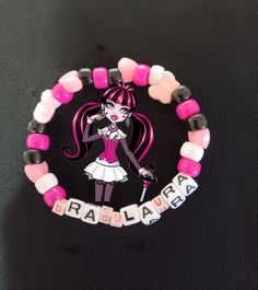 This is a Draculaure themed Kandi Bracelet. This is perfect for fans of our favorite pink vampire and vegan. Pink Adjustable Themed Charm Bracelet, Adjustable Pink Themed Charm Bracelet, Pink Themed Adjustable Charm Bracelet, Personalized Pink Novelty Charm Bracelet, Pink Adjustable Themed Beaded Bracelets, Pink Themed Adjustable Beaded Bracelets, Adjustable Pink Themed Beaded Bracelets, Pink Handmade Themed Bracelets, Themed Handmade Pink Bracelets