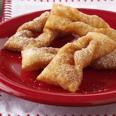 a red plate topped with pastries on top of a table