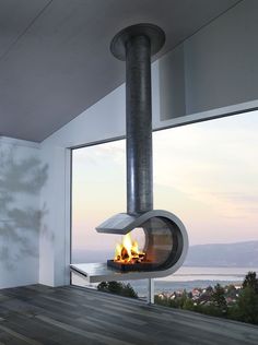 a fire burning inside of a fireplace in a living room next to a large window