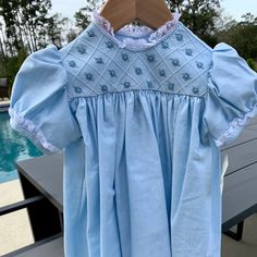 This Is A Beautiful Linen Dress In A Baby Blue Color With With Lace Around The Collar And Sleeves. The Chest Of The Dress Has Woven Flowers In A Squared Stitched Pattern. The Back Buttons At The Neck With 2 White Buttons. This Item Is A Size 2 But I Will Be Listing The Entire Size Run So If You Need To Match Sisters Or Cousins For Easter Or Perhaps To Be In A Wedding, I Might Have Your Sizes. All Items Are Direct From The Maker And They Are First Run Items Through My Boutique. Cotton Short Sleeve Dress For Baptism, Fitted Light Blue Cotton Dress, Blue Cotton Dress For Dress-up, Fitted Blue Dress For Baptism, Cotton Baptism Dress With Lining, Blue Cotton Dress-up Dresses, Blue Lace Trim Dress For Baptism, Light Blue Spring Baptism Dress, Light Blue Baptism Dress For Spring