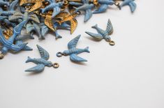 small blue and gold birds are scattered on a white surface