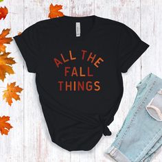 All The Fall Things in a modern font graphic on front in cream or multi Fall colors. Youth Sizes S-XL (unisex sizing) Toddler Sizes 2T, 3T, 4T To view All The Fall Things Adult T-shirts click here.To view All The Fall Things Baby Bodysuit click here.Bella + Canvas4.2 oz. Airlume combed and ring-spun cottonPre-shrunkFor a more relaxed fit, size up! Black Slogan T-shirt For Fall, Trendy Screen Print T-shirt For Fall, Fall Graphic Print T-shirt, Fall Slogan T-shirt With Relaxed Fit, Fall Slogan T-shirt Relaxed Fit, Tri-blend Graphic Tee For Fall, Trendy Fall Letter Print T-shirt, Fall Relaxed Fit Slogan T-shirt, Trendy Letter Print T-shirt For Fall