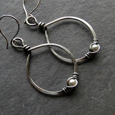 Eco friendly sterling silver (16G) has been hand formed and hammered into hoops. An organic spiral has been wire wrapped around a 4mm cream Swarovski pearl. The hoops have been oxidized and lightly brushed with steel wool and then polished for a soft patina. Ear wires are hand formed from sterling silver. Earrings measure 2.75 inches from top of ear wire to bottom of teardrop. All silver used has come from a recycled source. Thank you for looking! Pam :) Back to this shop-----> http://www.ets Classic Handmade Teardrop Hoop Earrings, Handmade Silver Hoop Earrings For Everyday, Silver Hand Forged Hoop Earrings For Anniversary, Silver Hand Forged Earrings For Everyday, Silver Wire Wrapped Round Bead Earrings, Silver Wire Wrapped Hoop Earrings, Silver Teardrop Wire Wrapped Hoop Earrings, Hand Forged Teardrop Silver Hoop Earrings, Everyday Handmade Silver Hoop Earrings