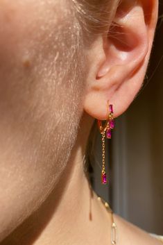 Our tiniest huggies made of 14K vermeil cz with 4 dangling tiny pink sapphire cz gemstones and tiny chain. So cute an everyday earring or as an addition to your ear game. Gem Earrings Gemstones, Ears Pirsing, Infinite Jewelry, Pink And Gold Jewelry, Bts Jewelry, Gemstones Earrings, Pink Ruby, Gem Earrings, Dope Jewelry