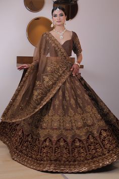 Brown lehenga with all over dome, floral embroidery including attached cancan. Comes with embroidered padded blouse and dupatta.
Component: 3
Pattern: Embroidery
Type Of Work: Floral, Dome
Neckline: Sweetheart
Sleeve Type: Half
Fabric: Raw Silk, Organza
Color: Brown
Other Details: 
Scallop border dupatta
Attached lining
Approx weight (in kgs) : 7 to 8
Closure: Lehenga - Drawstring
Occasion: Wedding - Aza Fashions Brown Lehenga, Raw Silk Embroidery, Scallop Border, Padded Blouse, Embroidery Floral, Pattern Embroidery, Silk Organza, Silk Embroidery, Brown Floral