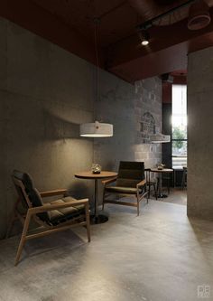 two chairs and a table in a room with concrete walls, floor to ceiling windows