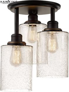 three light fixture with clear glass shades and black metal fittings on the bottom half