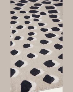 a black and white rug with spots on it