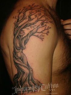 a man with a tree tattoo on his shoulder