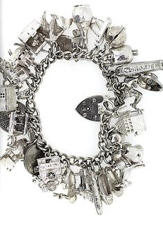 A vintage Sterling Silver curb bracelet with 29 Silver charms soldered on. This has a heart clasp with safety chain so it cannot be lost. The charms obviously vary in style, are very detailed and include:Submarine, signal box, bells, ballet shoes, coins, motorbike, airplane, pram etc etcThese charms will have been collected over many many years and will nearly all be irreplaceable today. Luxury White Gold Charm Bracelet With Sterling Silver Clasp, Luxury Antique Charm Bracelet, Cheap Vintage Charm Bracelet, Luxury Metal Charm Bracelet With Vintage Charm, Gothic Charm Bracelet, Silver Charm Bracelets, Aesthetic Silver Jewelry, Charm Bracelet Vintage, Pearl Rings Vintage