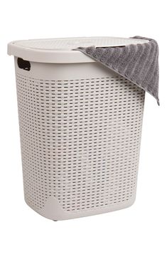 a white laundry basket with a gray towel on top