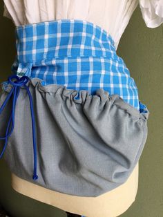 the back of a woman's blue and white checkered skirt