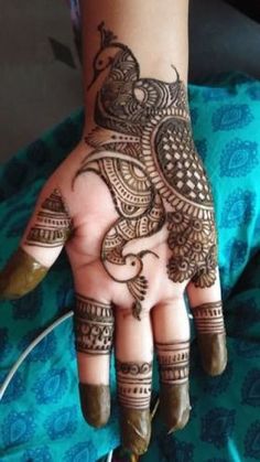 henna tattoo on the palm of a woman's hand