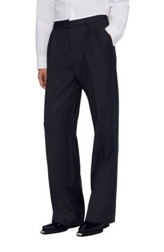 Straight-leg, oversize wool trousers with ironed creases, embellished with fine stripes, side pockets and welt pockets on the back.           These trousers match the jacket  and tie Sandro Women's wool trousers Ironed creases Stripes Belt loops The model is 5'8 tall and wears a size 4 Pinstripe Straight Leg Dress Pants For Business, Striped Wide Leg Business Pants, Business Pinstripe Dress Pants Straight Leg, Striped Dress Pants With Welt Pockets For Work, Classic Pinstripe Dress Pants For Office, Striped Wide Leg Pants For Business, Wide Leg Striped Pants For Business, Elegant Striped Formal Pants, Tailored Pinstripe Pants For Formal Occasions