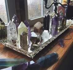 several crystals are sitting on a tray in front of a window