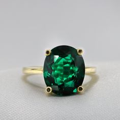 "Handmade by an inspired jewelry artist team with decades of experience in the craft of jewelry making. Each gemstone, each diamond is carefully picked. Using only the finest raw materials and the highest industry standard in manufacturing, design and finish. Luxurious and stylish, A ring for all true Emerald lovers Prong set is a beautiful oval cut Green emerald with an amazing depth and clarity Built to last a lifetime. Ring Features *Center Stone: 12 x 10 Oval cut, Chatham Green Emerald 4.25c Emerald Gold Ring, Emerald Solitaire Ring, Solitaire Bands, May Birthstone Rings, Ring Rosegold, Emerald Ring Gold, Wedding Ring For Her, Promise Ring Gift, Jewelry Artist