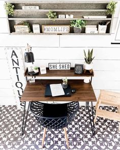 a desk with two chairs and a shelf above it that says she shed on the wall