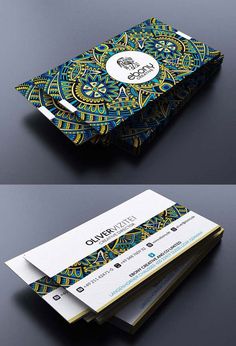 two business cards are stacked on top of each other, one with an ornate design