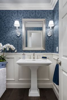 a bathroom with blue and white wallpaper is featured in the home design magazine's website