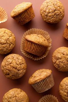 several muffins are arranged on a red surface