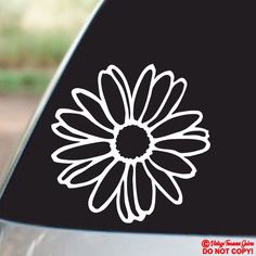 a white flower sticker on the side of a car