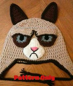 a crocheted hat with a cat wearing sunglasses on it's face and the words pattern only written below