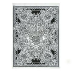 a black and white square scarf with an ornate design on the front, in grey tones