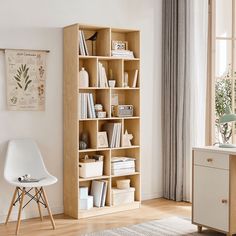 a white chair sitting in front of a book shelf