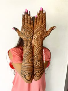 a woman with her hands painted in henna