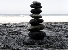 a stack of rocks sitting on top of a sandy beach