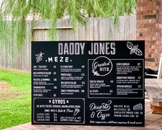 the menu for daddy jones'meze sits outside