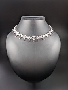 This delicate lace necklace can be worn as a choker at 15 1/2 inches, or just grazing the collar bones as a princess length necklace at 18 1/2 inches or at any length in between. The silver lobster claw clasp and 3 inch extender chain make it a versatile accessory. It is made of white pearlized seed beads, white czech pearls (imitation) and pale rose bicone crystals. The lacey beadwork is strung together with Wildfire beading thread woven through each bead multiple times for strength. This beautiful confection could be worn to a wedding or nice dinner out.  The pattern by for this necklace is by Anne Lazenby. Beaded Chocker, Crystal Lace, Nice Dinner, Rose Crystal, Beading Thread, Lace Necklace, Length Necklace, Choker Necklaces, A Princess