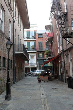 an alley way with cars parked on both sides