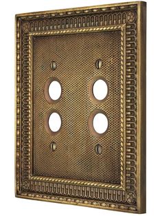 an old fashioned metal wall plate with three holes in the middle and two on each side