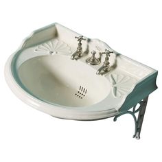 a white sink with two faucets on the side and an iron stand underneath it